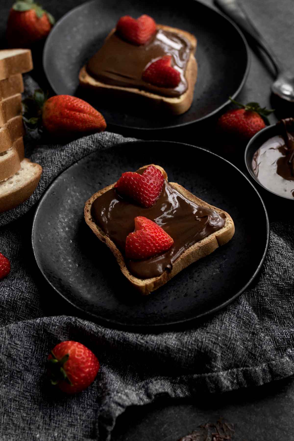 Nut Free Chocolate Spread on toast with strawberries cut like hearts.