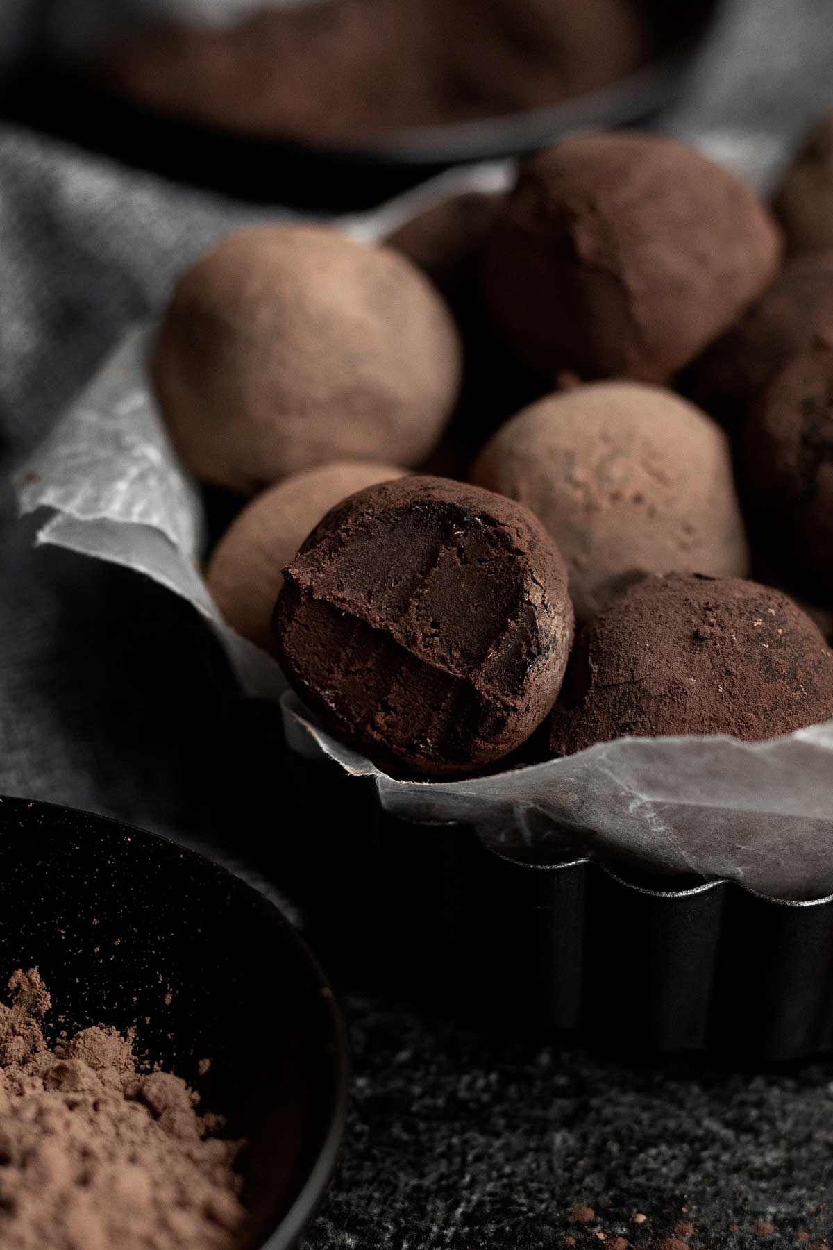 Gluten free and nut free Chocolate Truffles arranged on a plate in cupcake wrappers.