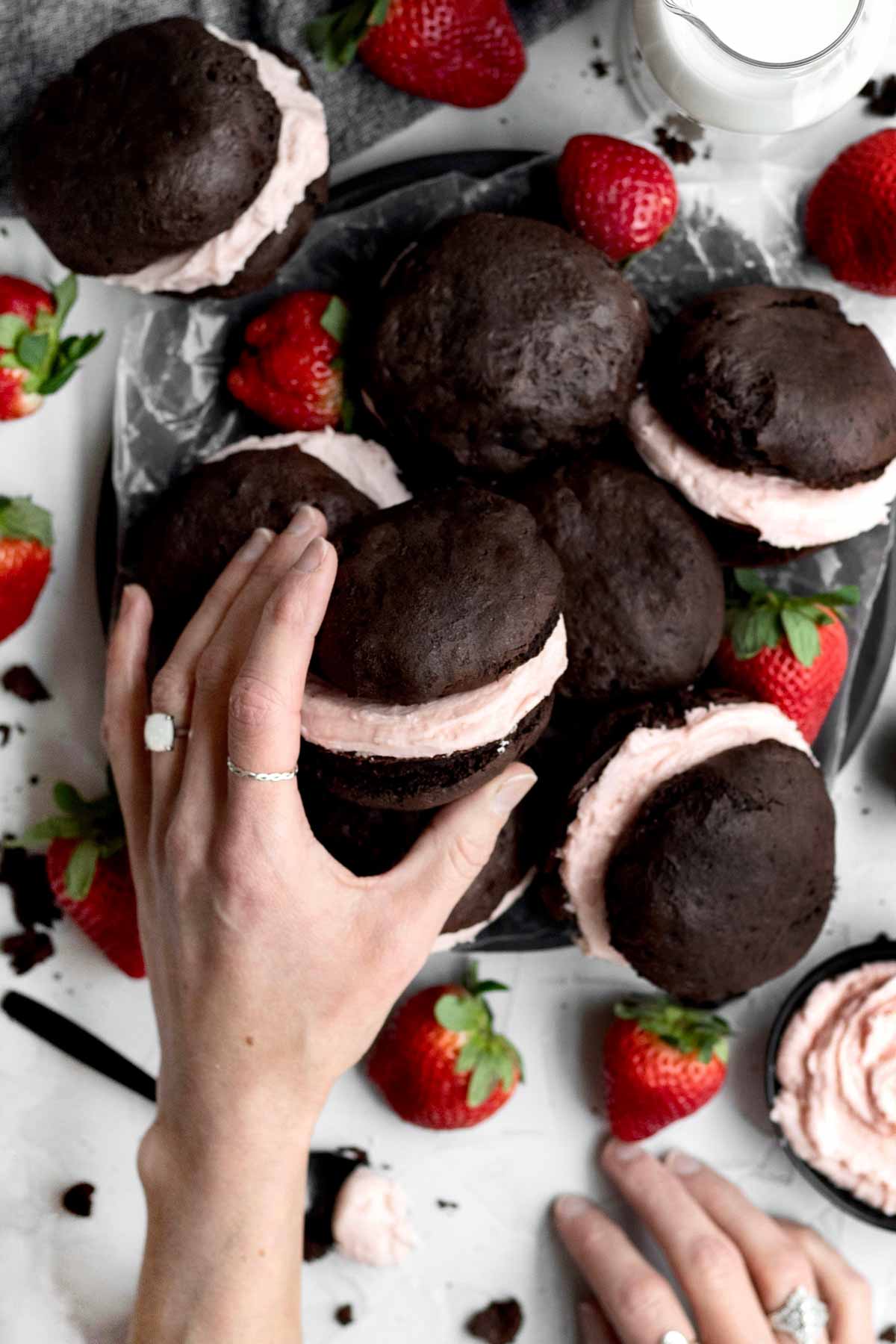 A lady’s hand reaches for a gluten free Whoopie Pie.