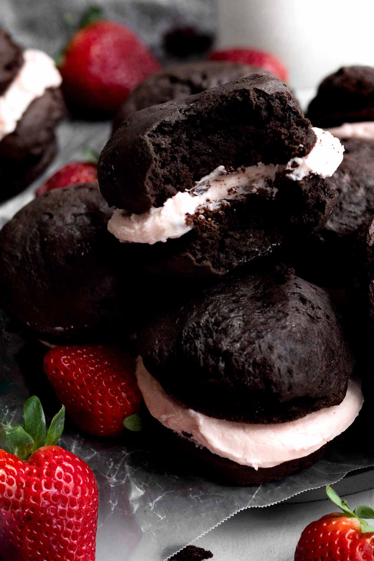 A pile of Whoopie Pies, one with a bite.