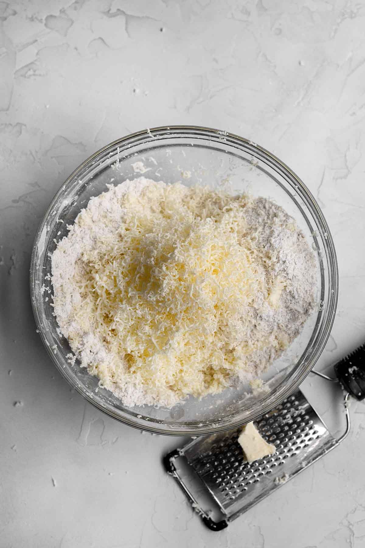 Grated butter added to the dry ingredients mixture.