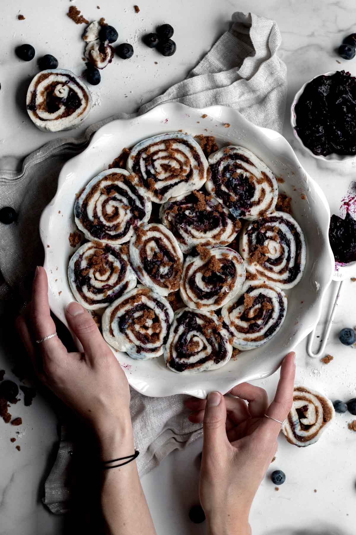 Spirals of unglazed Blueberry Cinnamon Rolls packed into a baking dish.