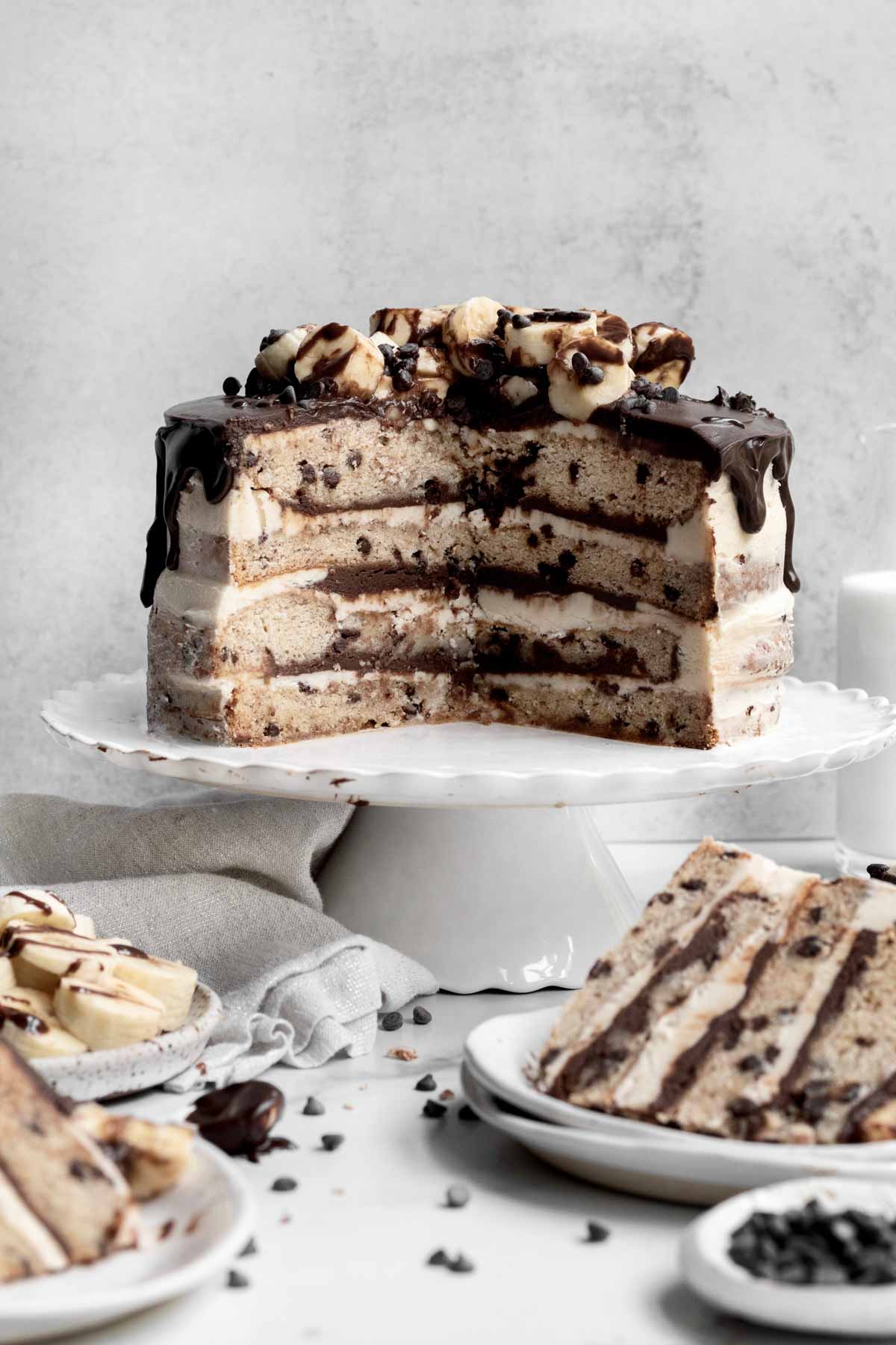 Missing slices reveal the four alternating layers of the cake, frosting and chocolate ganache.