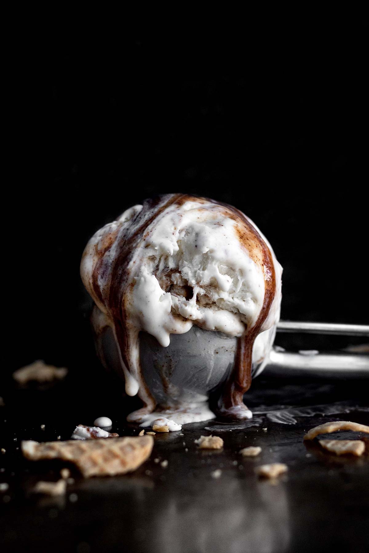 An ice cream scoop with melty Cinnamon Swirl Ice Cream.