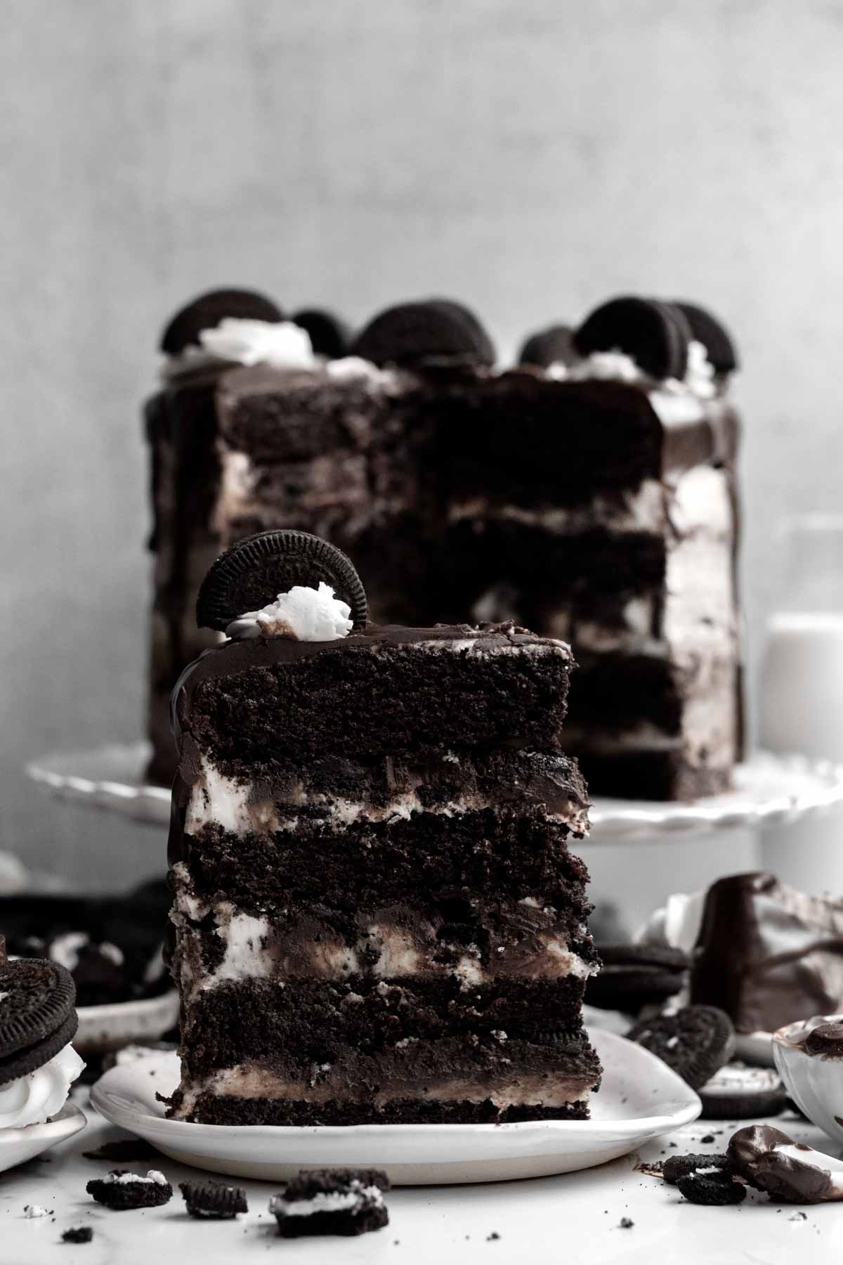 A slice of Cookies and Cream Cake standing triumphantly.