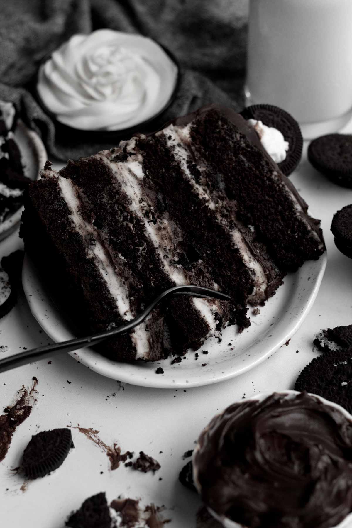 Taking a fork to the alternating layers of cake and cream.