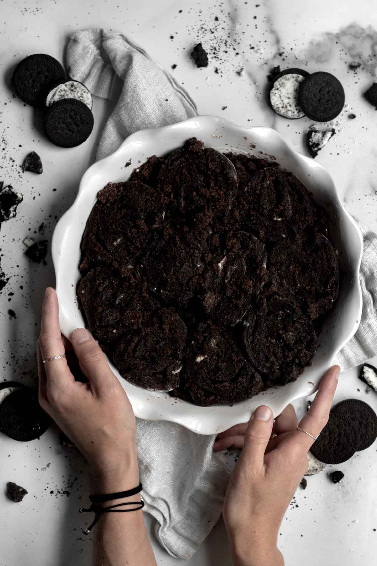 Dark brown rolls packed tightly into a round baking dish.