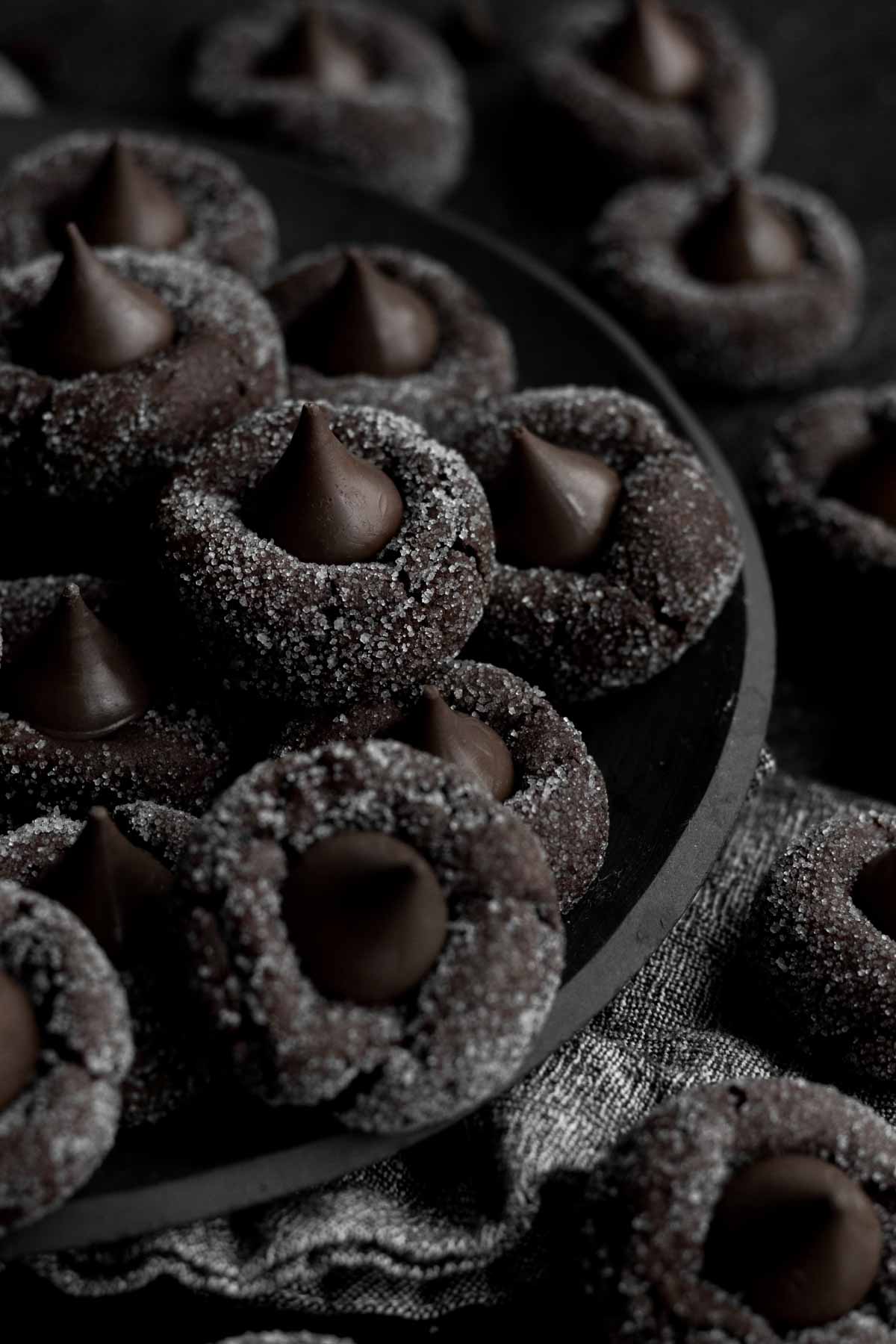 A dark and delicious full plate of warm Chocolate Blossom Cookies with crystalized sugar.