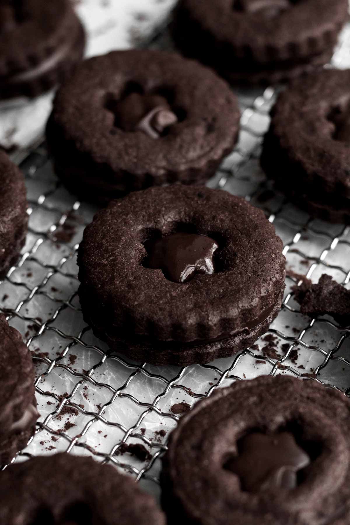 A dark gluten free Double Chocolate Sandwich Cookie with fudge.