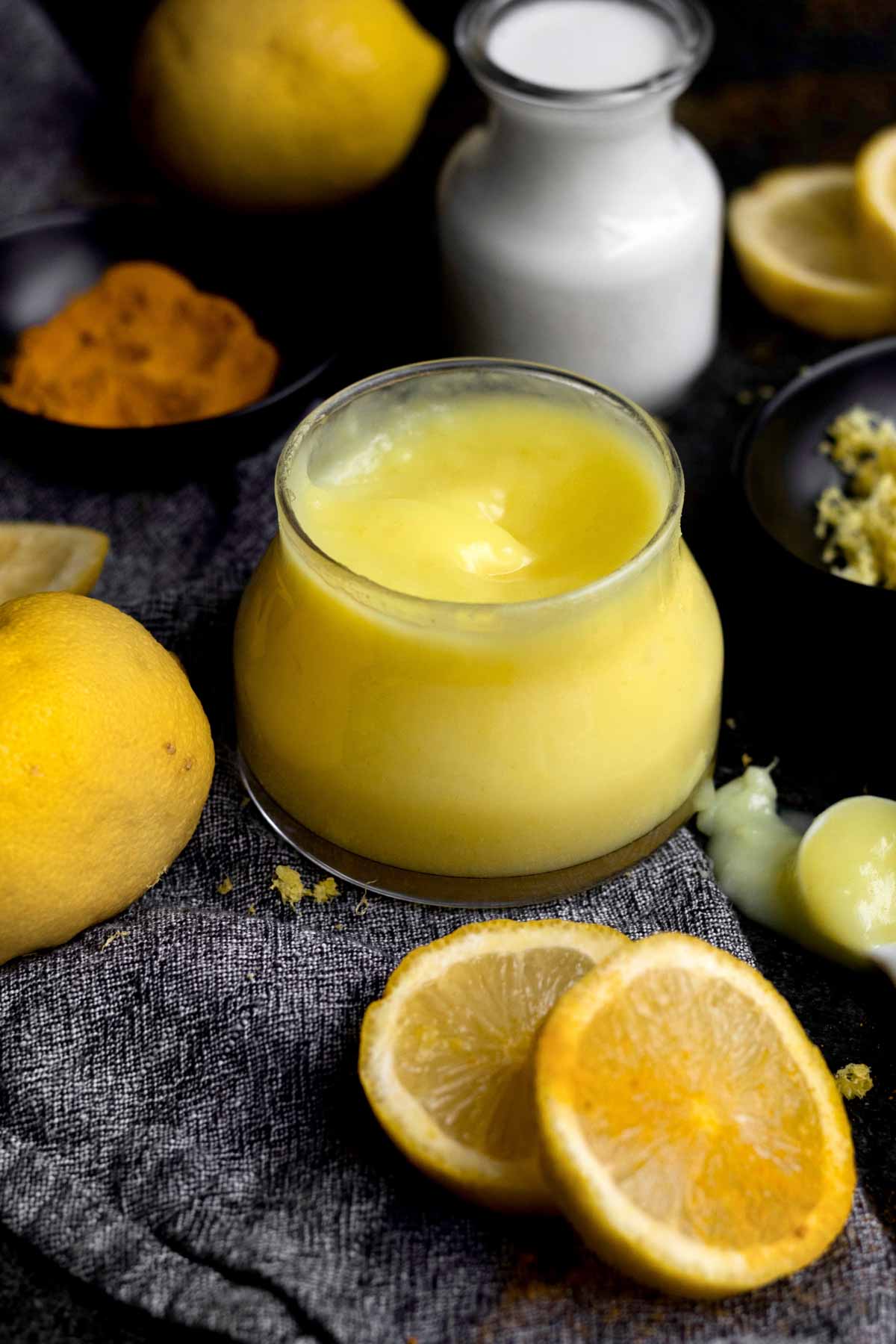 Bright yellow Eggless Lemon Curd in a glass ramekin.