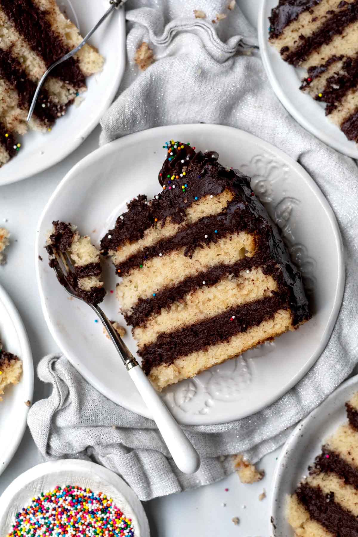 A slice of Gluten Free Birthday Cake on a plate.