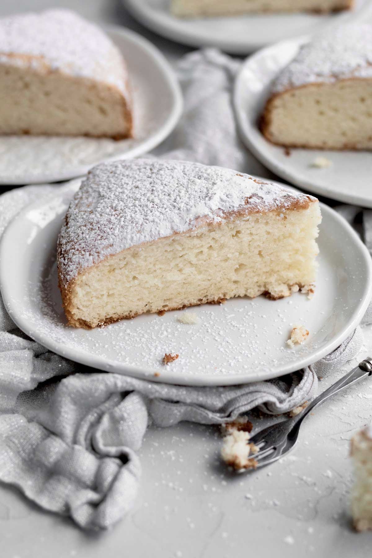 Light and airy, this Irish Tea Cake sits covered in powdered sugar.