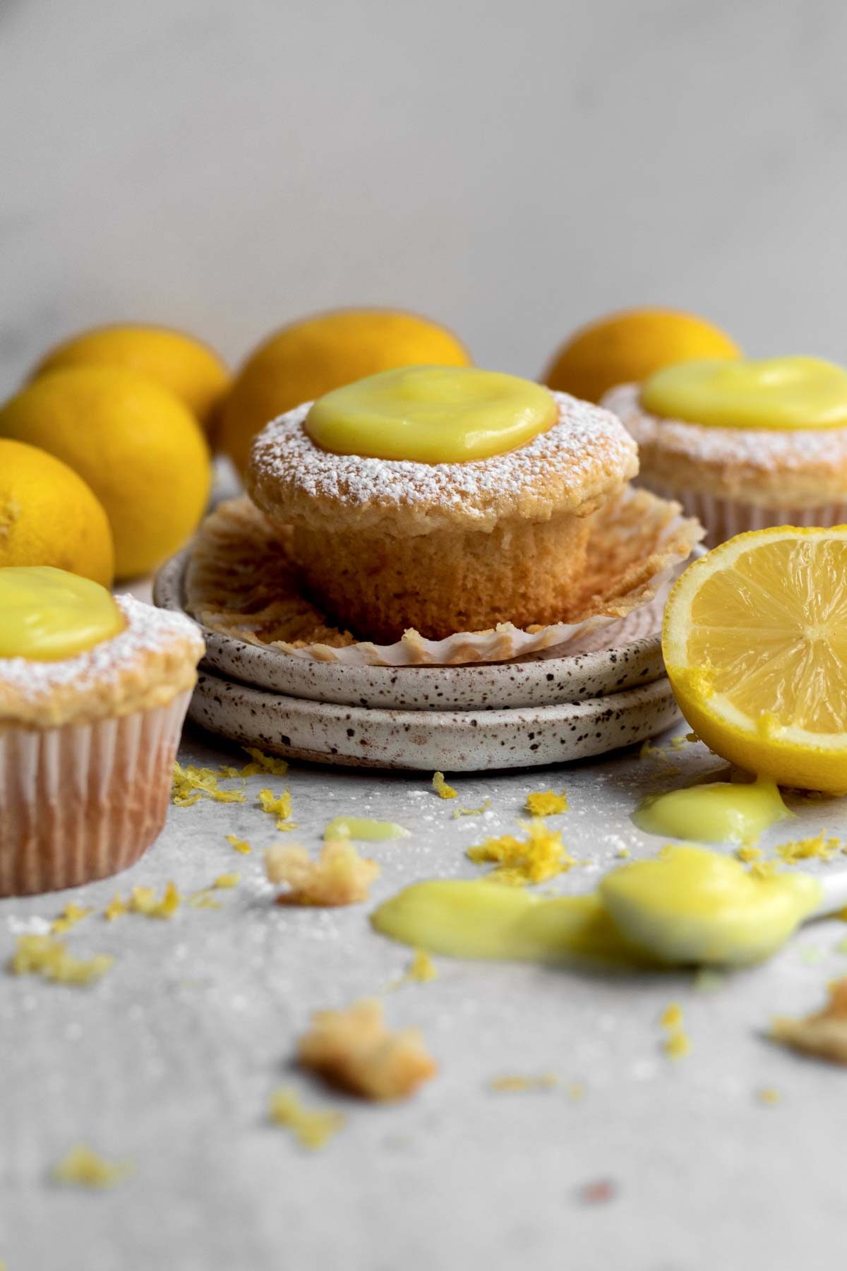 An unwrapped Vegan Lemon Cupcake with a circular dollop of lemon curd.