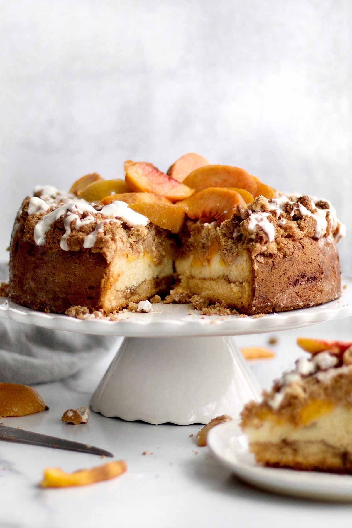 A Peach Cobbler Cake with a slice missing.