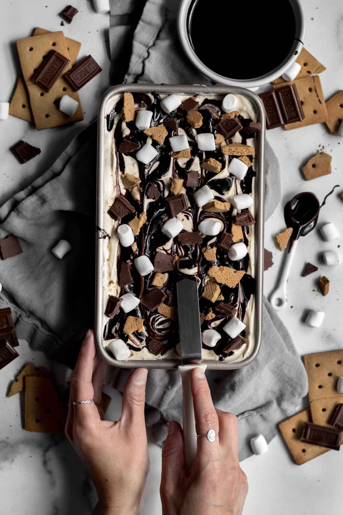 Pan of S’mores Ice Cream being mixed with a spatula.