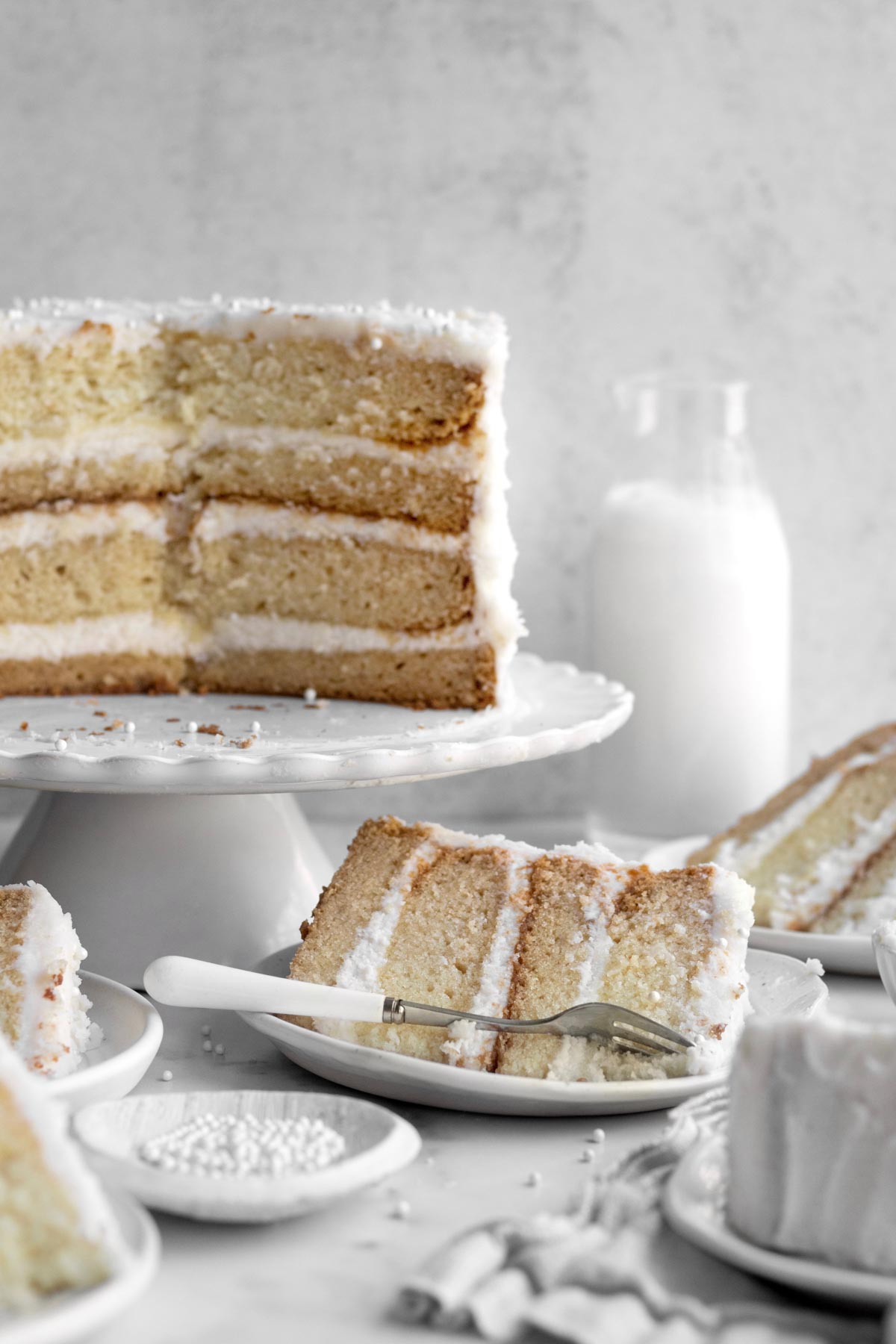 Gluten Free Vanilla Cake with alternating layers of cake and vanilla frosting.