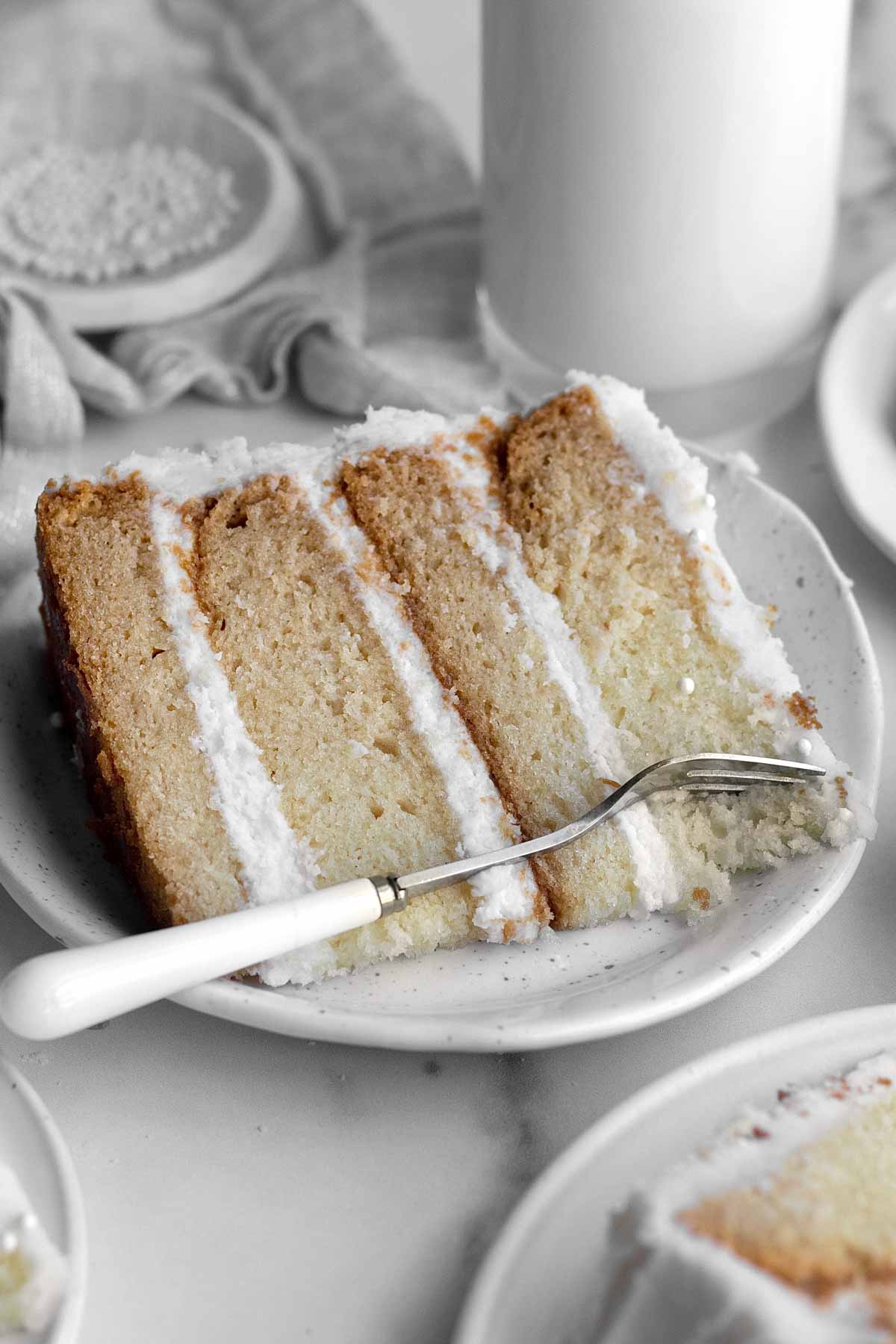 A slice of cake on a plate with a fork.